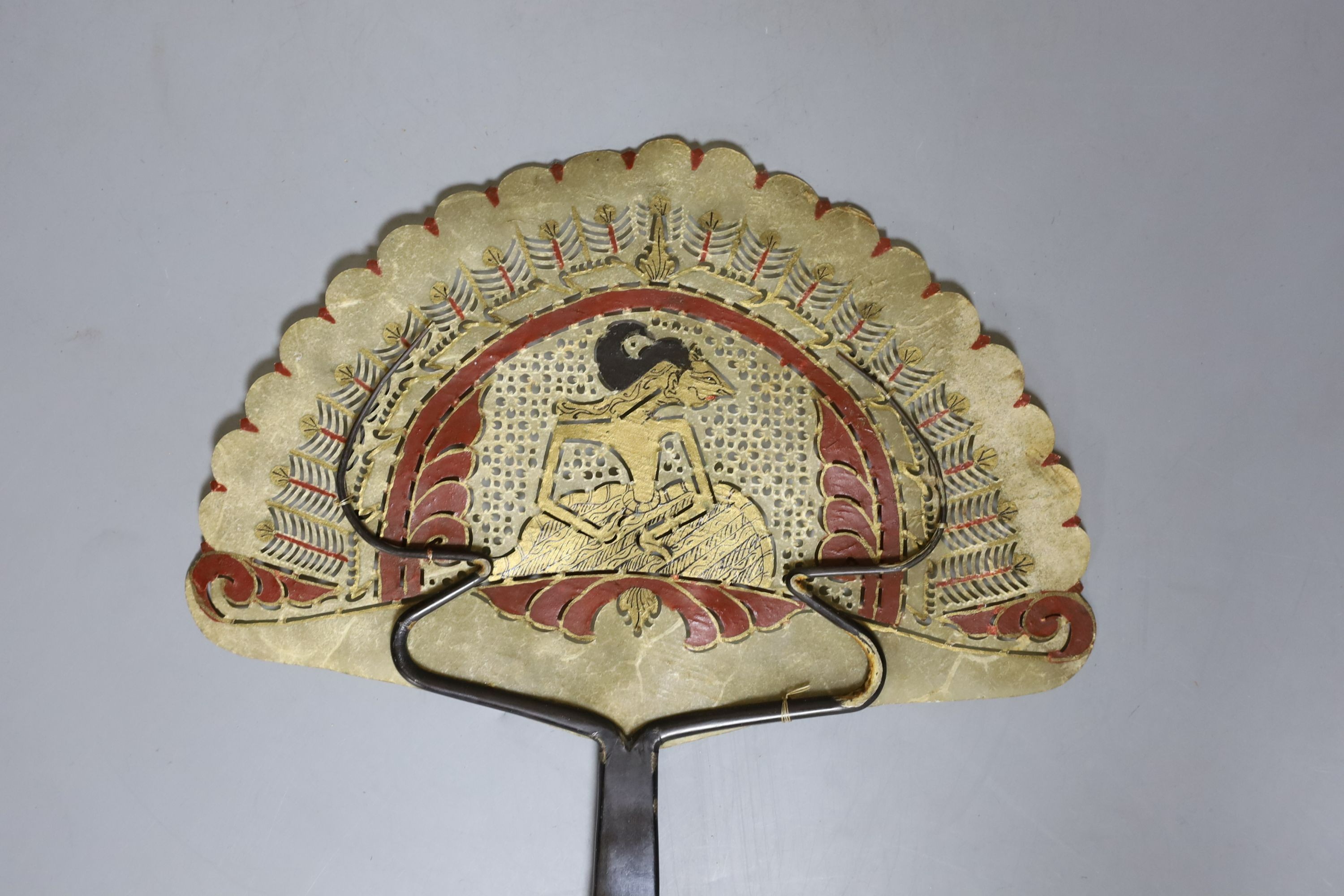 A Burmese carved hardwood figure, 51.5cm tall, and a Burmese horn and animal-bladder fan